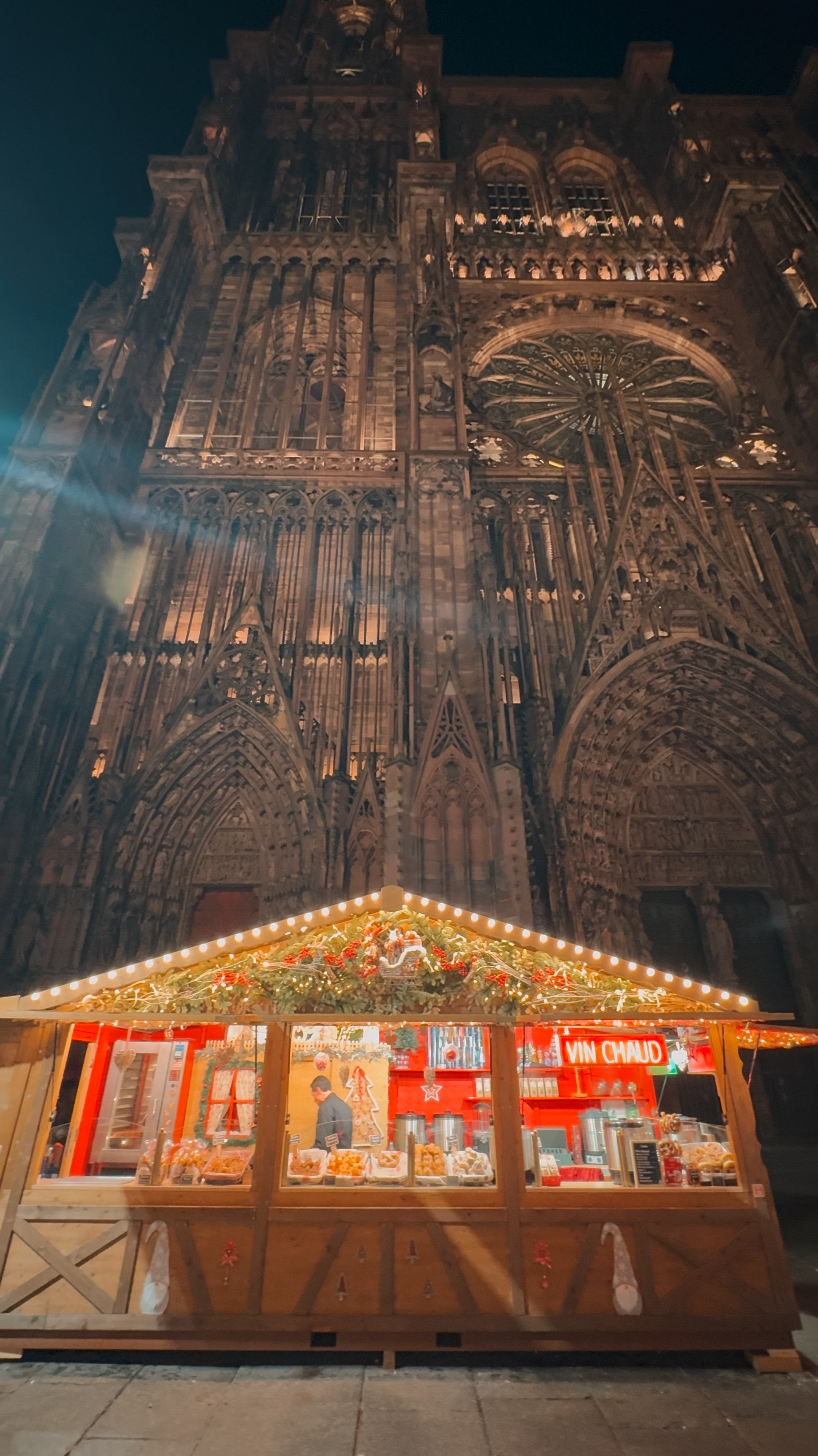 Strasbourg Cathedral with Christmas lights and market stalls in front