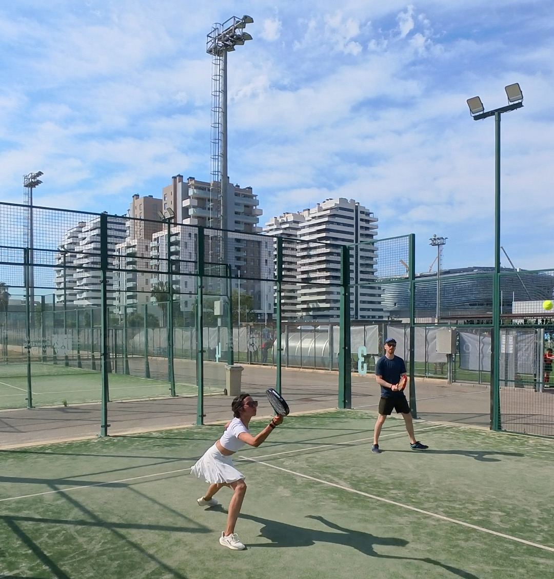Playing padel in Valencia with city buildings in the background, showing an active and social lifestyle